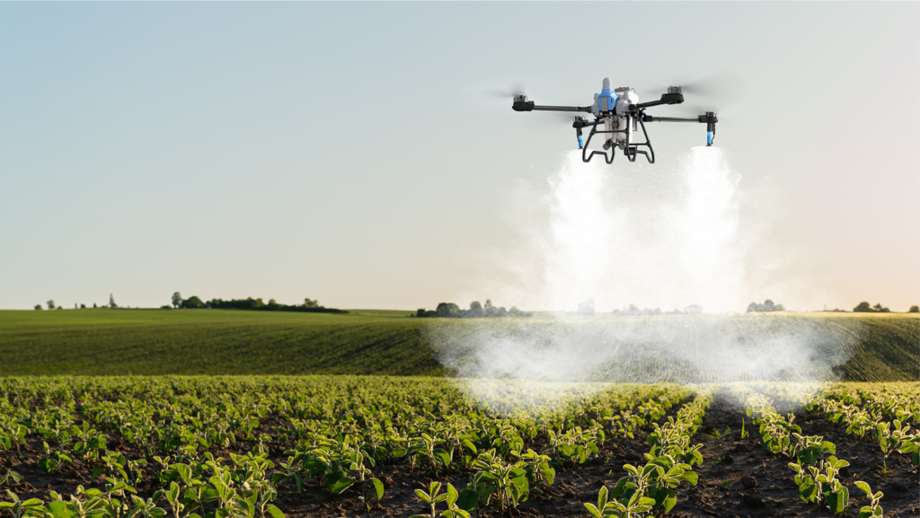 spray drone in a field at sunset