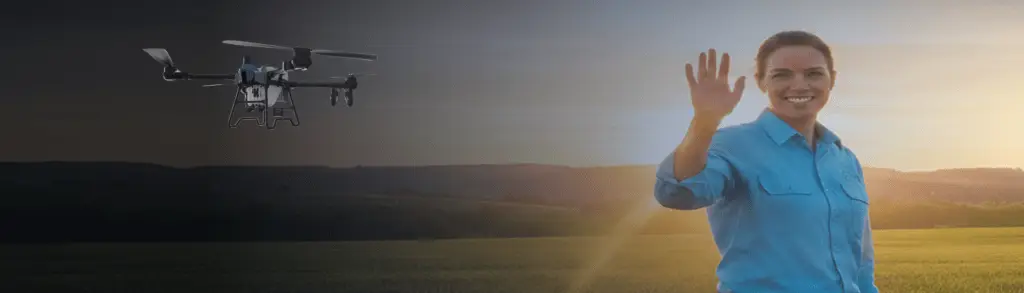 woman waving hello with ag drone flying in back field